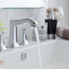 An image of a bathroom sink with a faucet and soap dispenser.