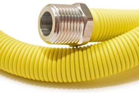 Yellow hose with threaded end, suitable for gas line pipe.