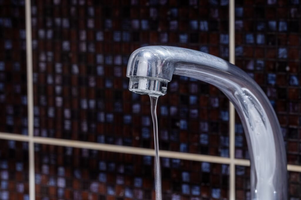 A faucet with water flowing steadily,illustrating normal water pressure,contrasting with low water pressure scenarios.