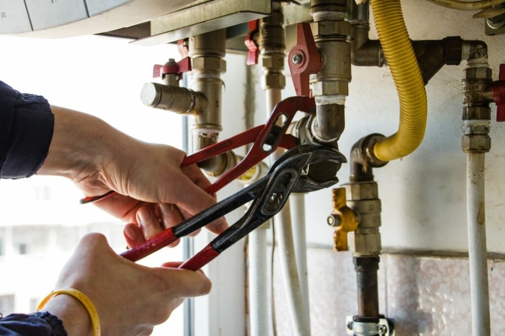 A professional plumber repairing a gas water heater, focusing on pipe repair and ensuring proper functionality.