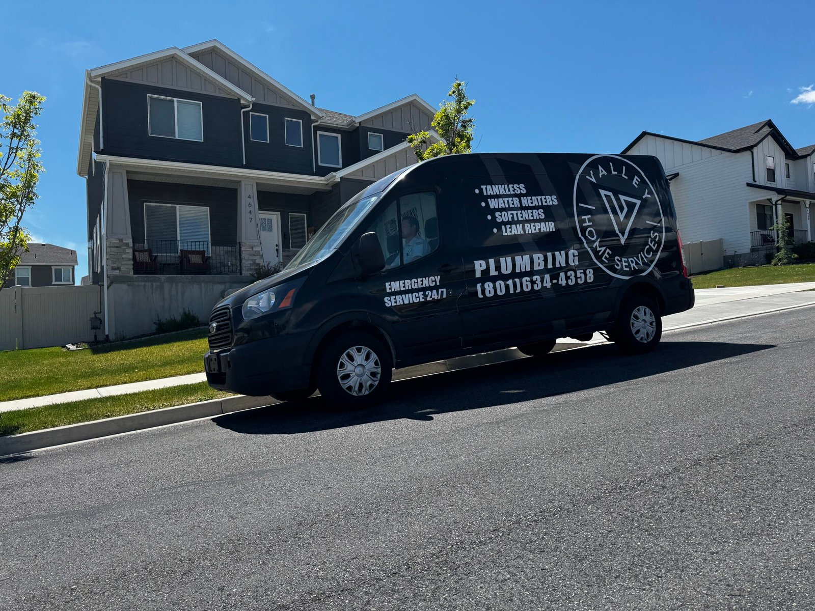 Valley Home Plumbing Services Black Truck in Front of a Home