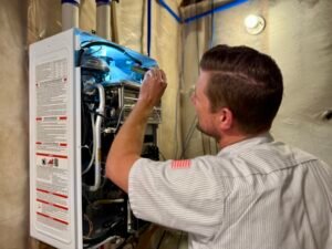 Chris Donahue, Master Plumber and an Owner of Valley Home Plumbing installing a Navien Tankless Water Heater 2