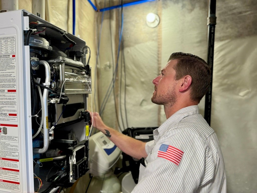 Chris Donahue, Master Plumber and an Owner of Valley Home Plumbing installing a Navien Tankless Water Heater 3